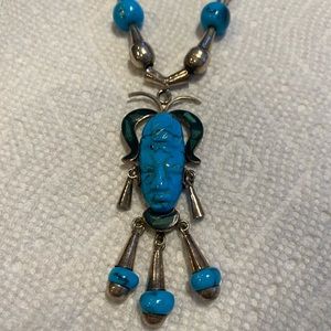 Silver and turquoise tribal mask necklace.